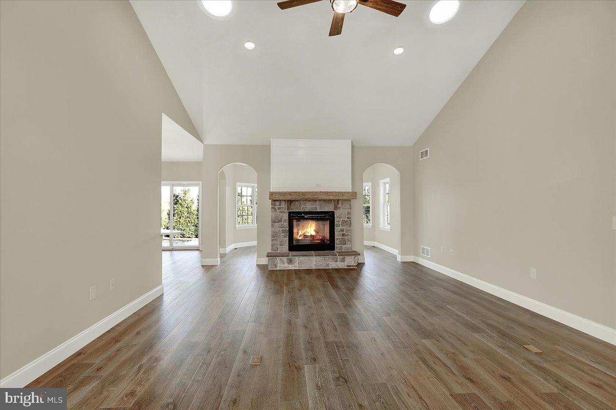 4 Rolling Meadow Road Lebanon, PA 17046 - Photo 4 of 37 an empty room with wooden floor fireplace and windows