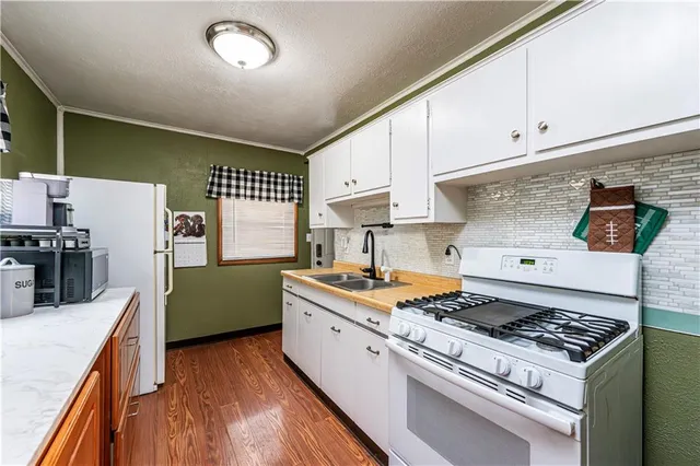 a kitchen with stainless steel appliances a sink and a stove