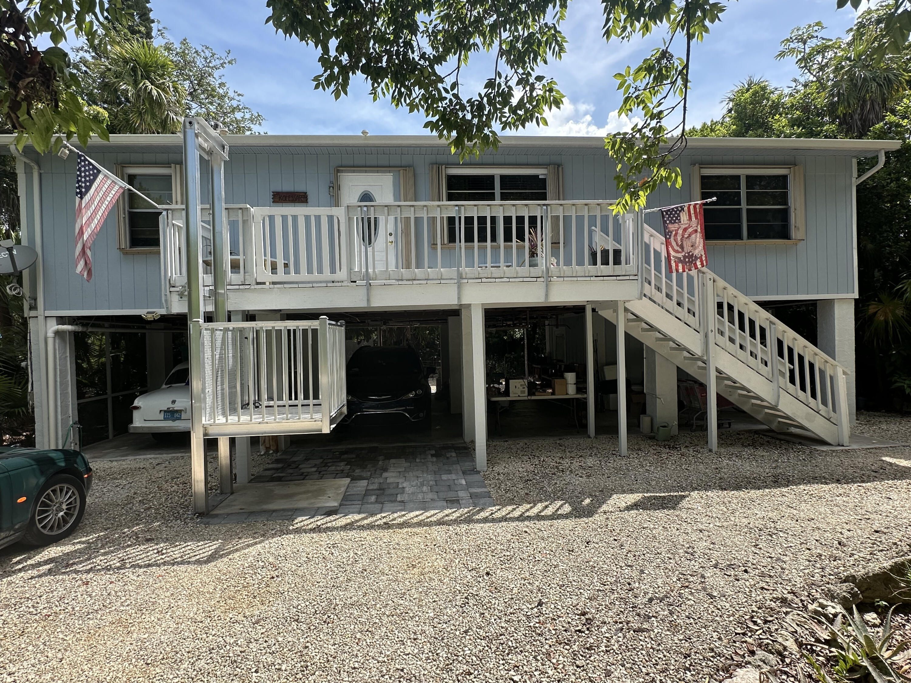 a view of house with a yard and deck