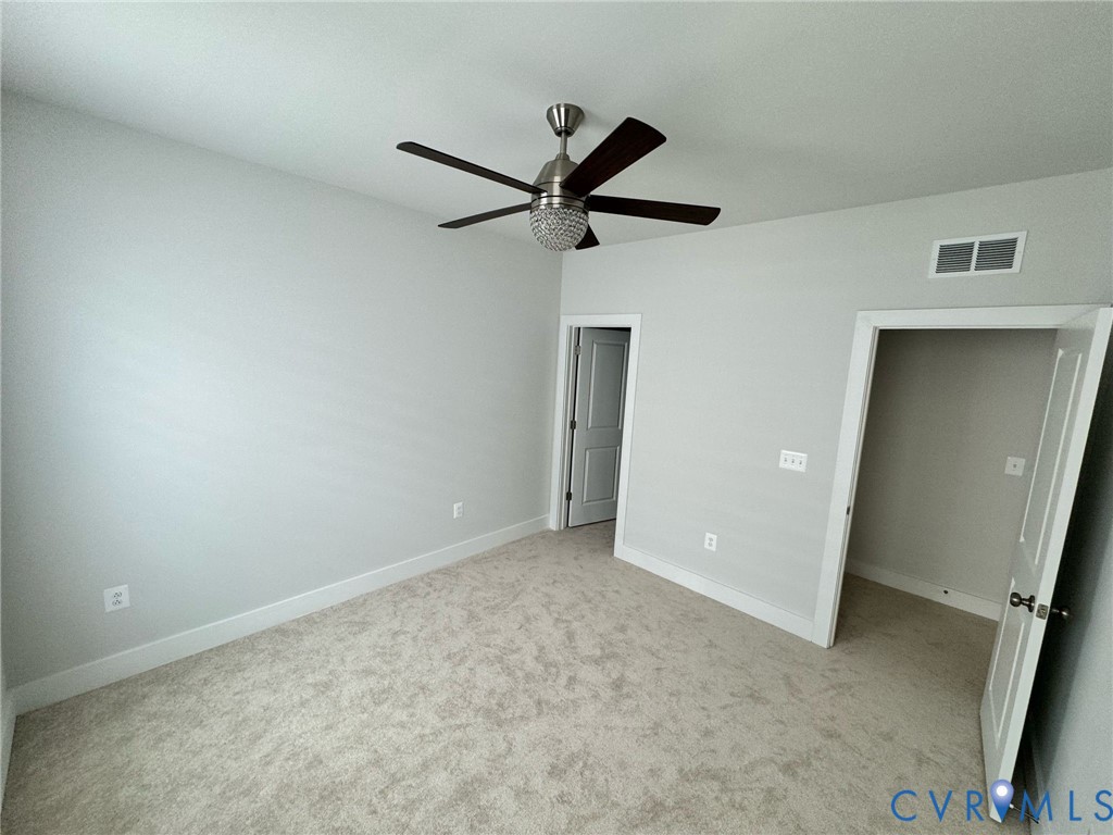 1512 West Moore Street, Unit B Richmond, VA 23220 - Photo 14 of 34 Unfurnished bedroom with light carpet and a ceilin