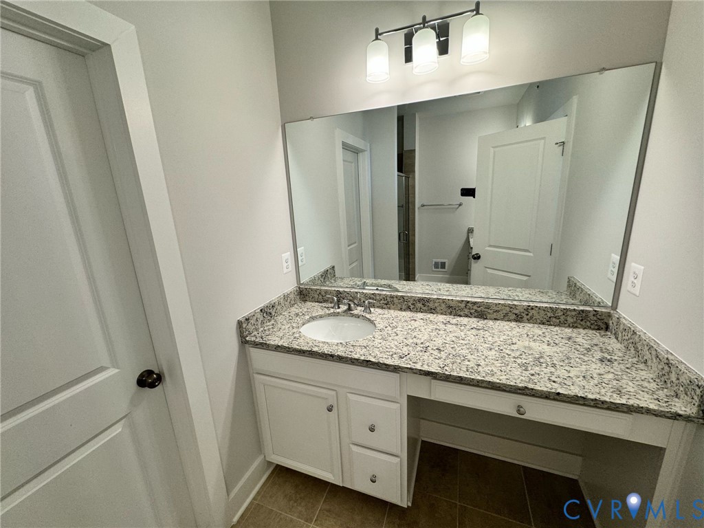 1512 West Moore Street, Unit B Richmond, VA 23220 - Photo 19 of 34 Bathroom with vanity, dark tile patterned flooring