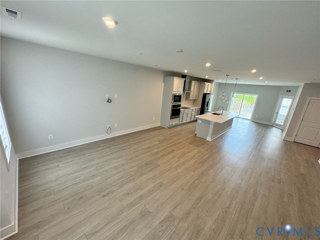 1512 West Moore Street, Unit B Richmond, VA 23220 - Photo 25 of 34 Unfurnished living room with recessed lighting and