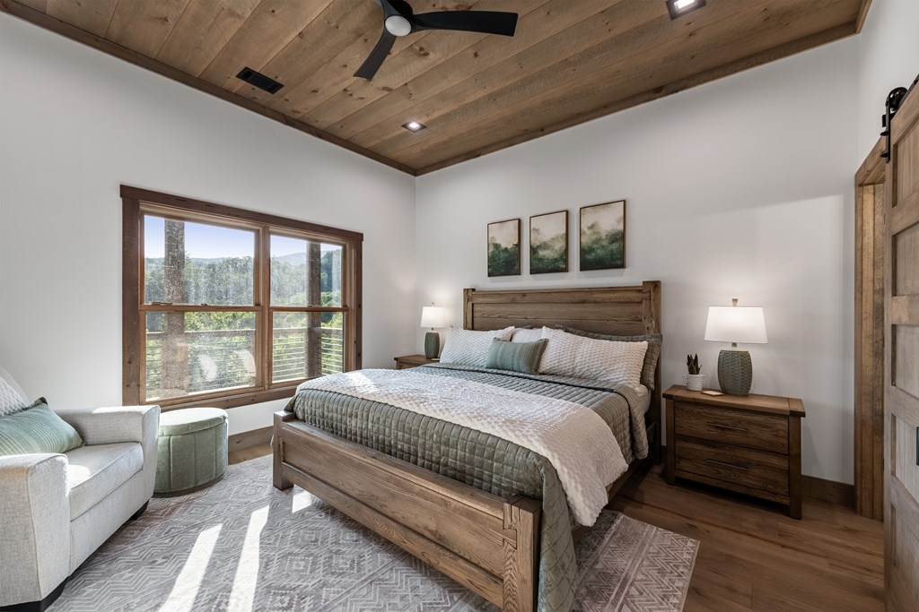 17 Rich Mountain Cherry Log, GA 30522 - Photo 22 of 57 a spacious bedroom with a bed a couch and a large window