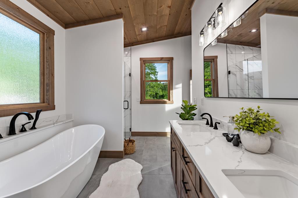 17 Rich Mountain Cherry Log, GA 30522 - Photo 50 of 57 a bathroom with a granite countertop sink a toilet a mirror and shower