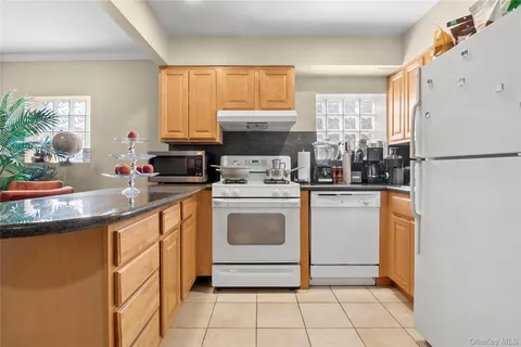 a kitchen with a stove a sink and a refrigerator