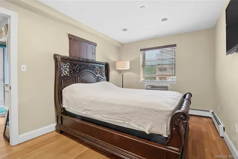 a large bed sitting in a bedroom next to a window