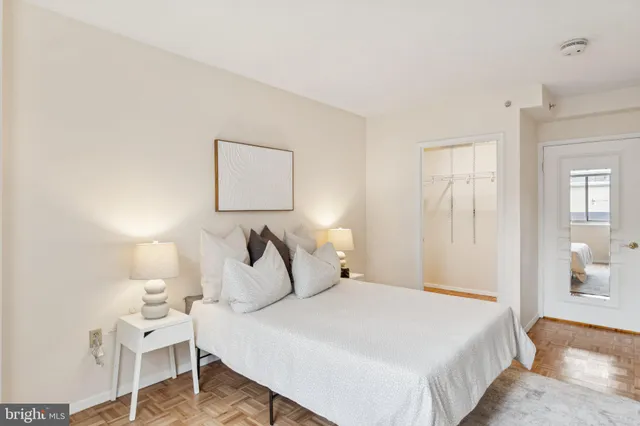 a bedroom with a bed and a lamp