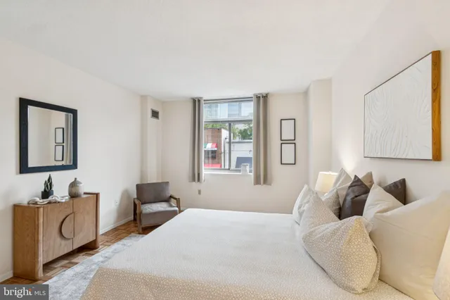 a bedroom with furniture and a window