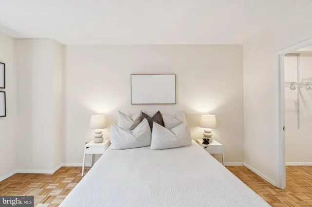 a bedroom with a bed and a lamp