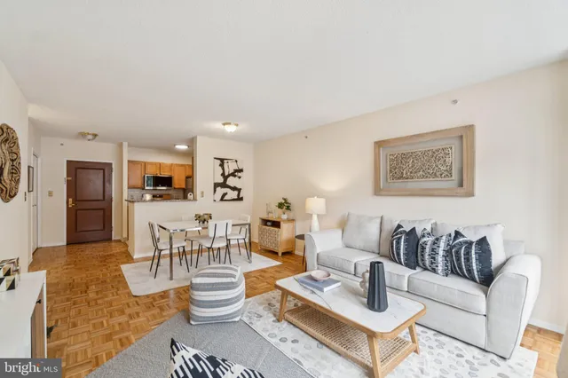 a living room with furniture and kitchen view
