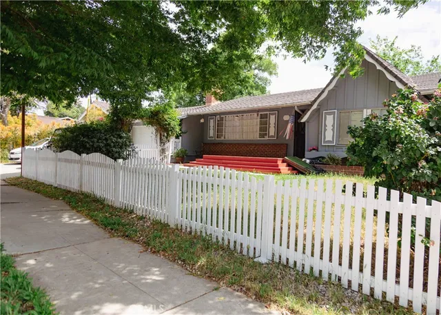 a front view of house with wooden fence