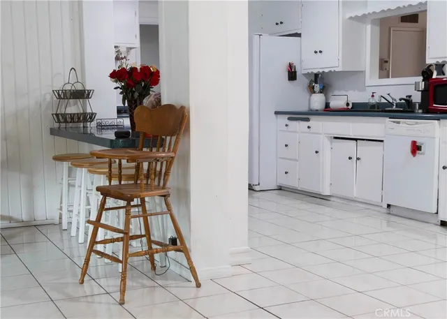 a kitchen with stainless steel appliances kitchen island granite countertop a sink and a cabinets
