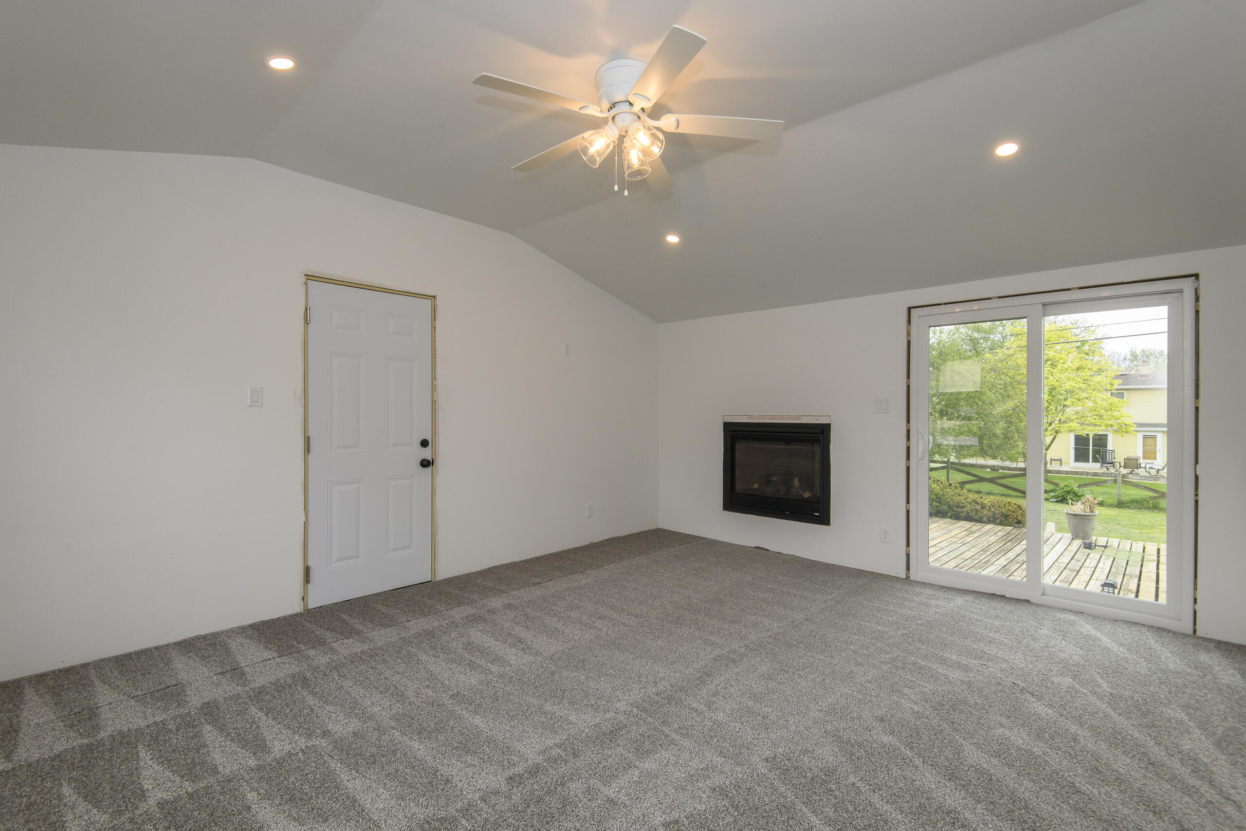 W271N2563 Pear Tree Lane Pewaukee, WI 53072 - Photo 9 of 47 Family room w/fireplace and patio doors