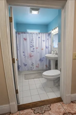 a bathroom with a toilet and a shower