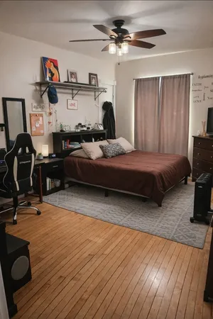 a bedroom with a bed and a chandelier