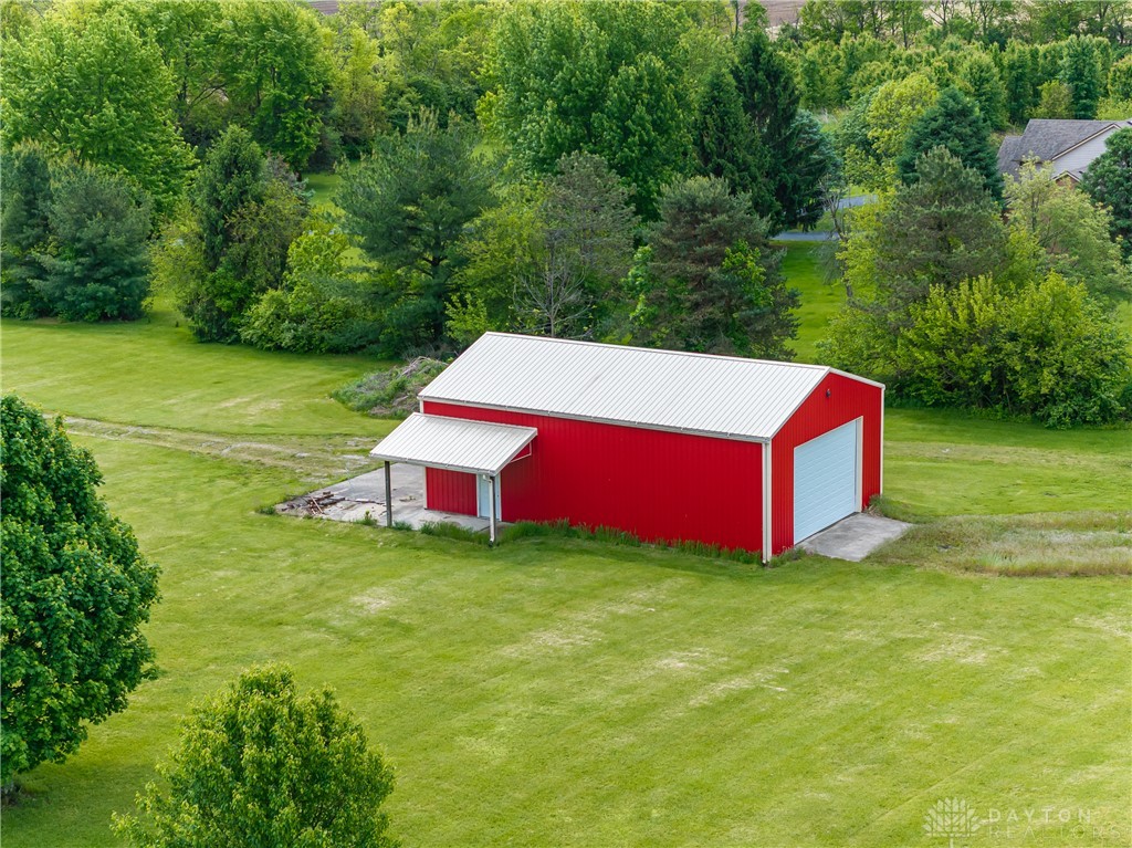9981 Ridge Acres Lane Englewood, OH 45322 - Photo 70 of 73 This expansive property features a vibrant red barn with a detached shed, set amidst lush green landscaping.
