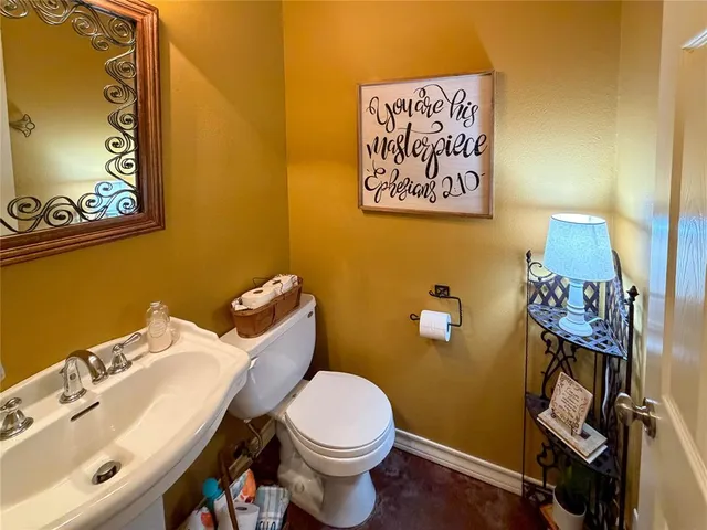 a white toilet sitting next to a bathroom sink