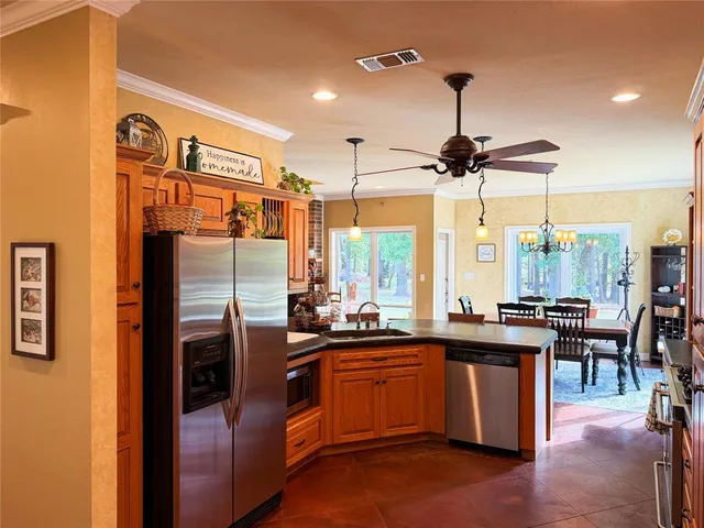 a kitchen with a sink a stove and chairs