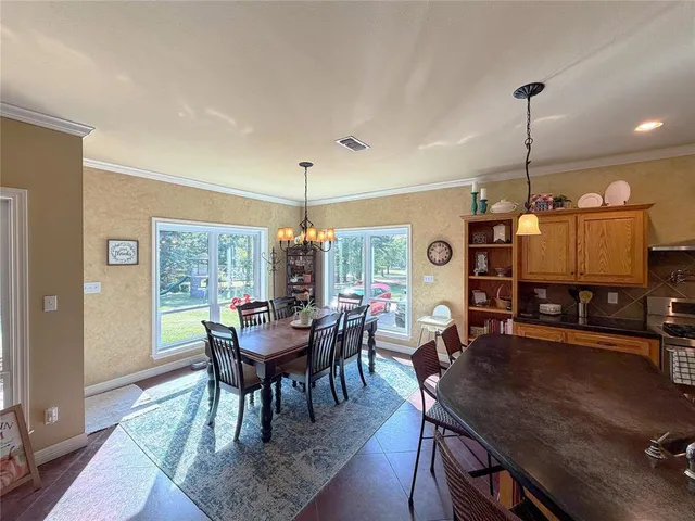 a view of a dining room with furniture window and outside view