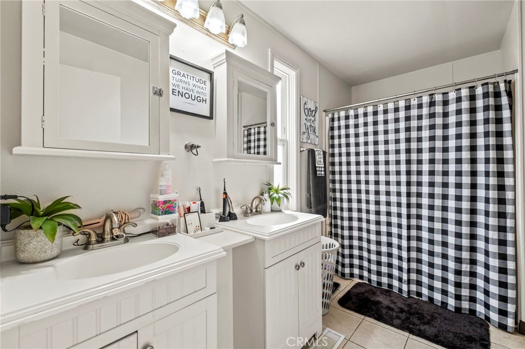 24847 Split Rail Road Wildomar, CA 92595 - Photo 13 of 45 a bathroom with a sink a vanity and a shower