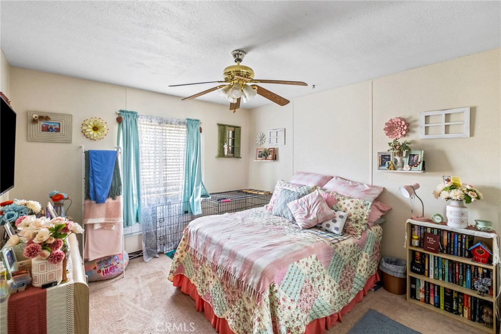 24847 Split Rail Road Wildomar, CA 92595 - Photo 16 of 45 a bedroom with a bed and dresser