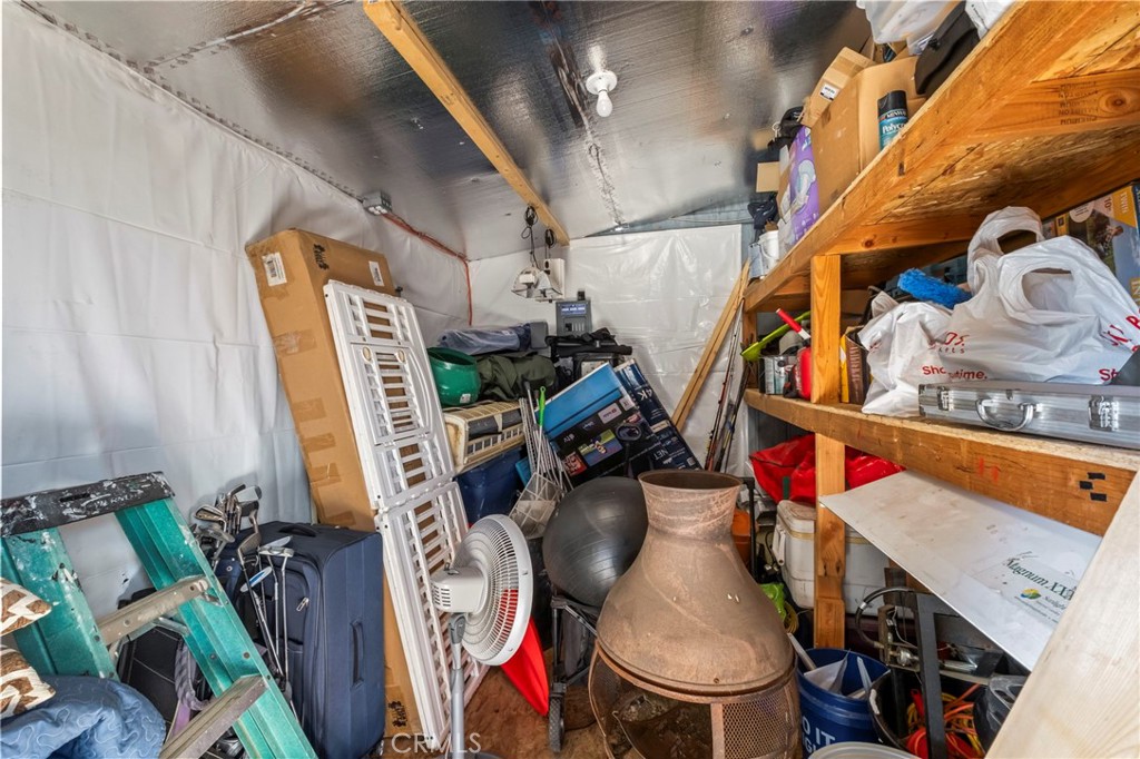 24847 Split Rail Road Wildomar, CA 92595 - Photo 30 of 45 a view of walk in closet with clothes and shoes
