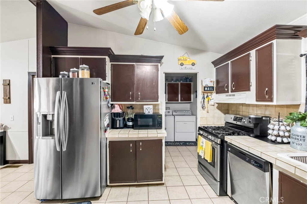 24847 Split Rail Road Wildomar, CA 92595 - Photo 3 of 45 a kitchen with stainless steel appliances granite countertop a refrigerator a stove and a sink