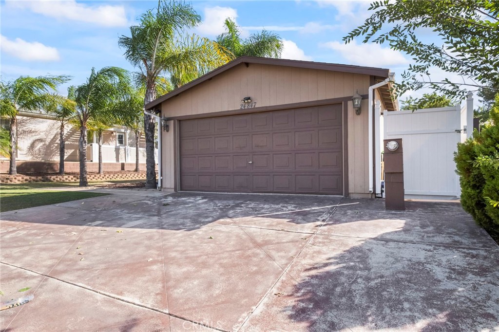 24847 Split Rail Road Wildomar, CA 92595 - Photo 42 of 45 a front view of a house with a yard and garage