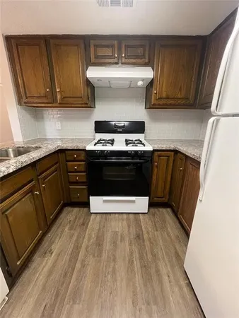 a kitchen with a stove and white cabinets