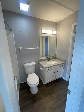 a bathroom with a toilet sink and a mirror