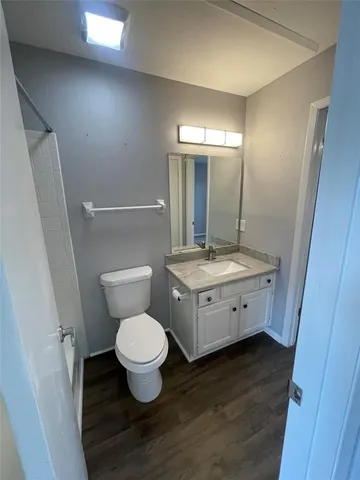 a bathroom with a toilet sink and a mirror