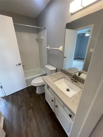a bathroom with a sink mirror and toilet