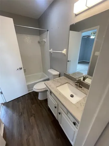 a bathroom with a sink mirror and toilet