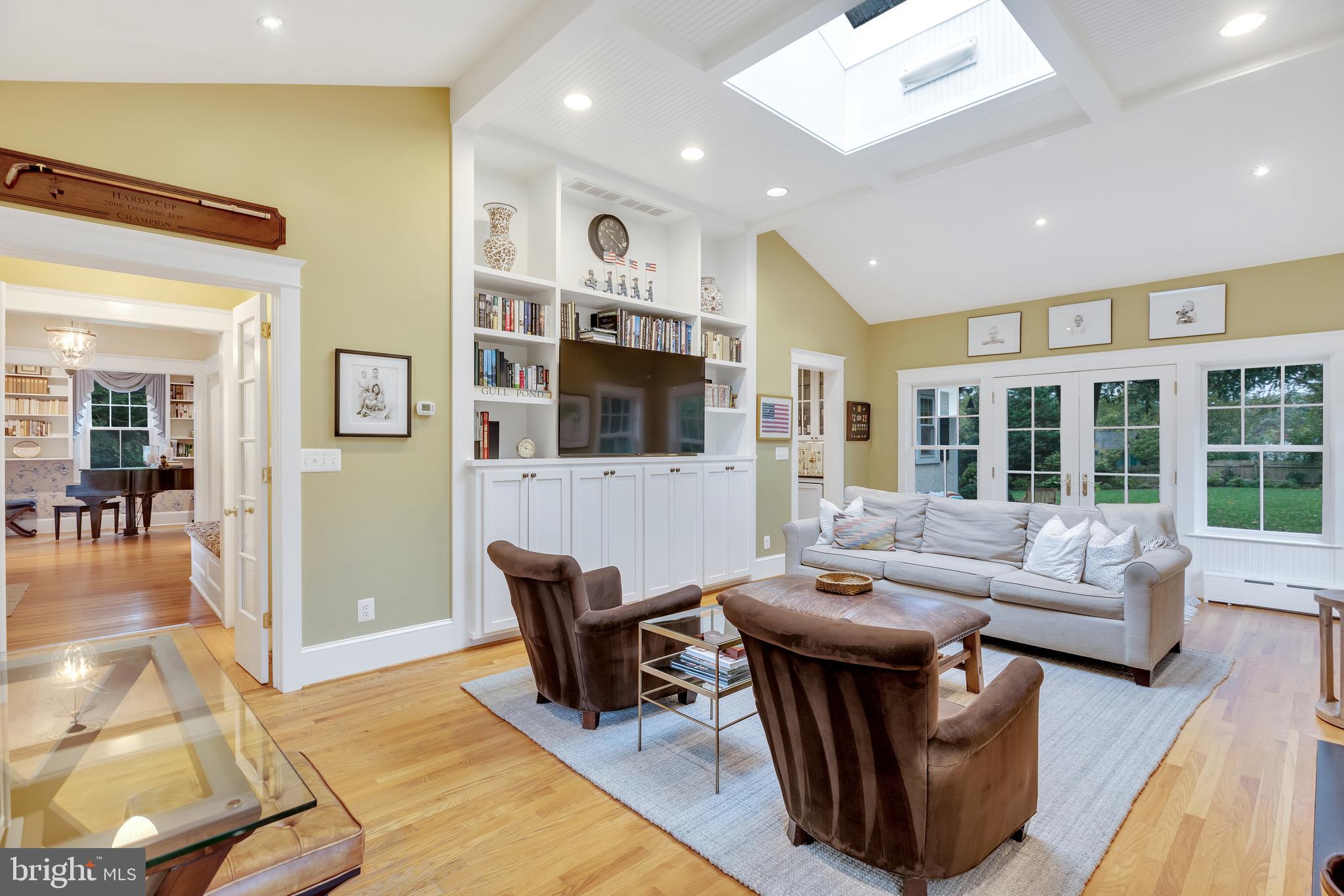 7506 Brookville Road Chevy Chase, MD 20815 - Photo 20 of 49 Family room with built ins and doorway to patio