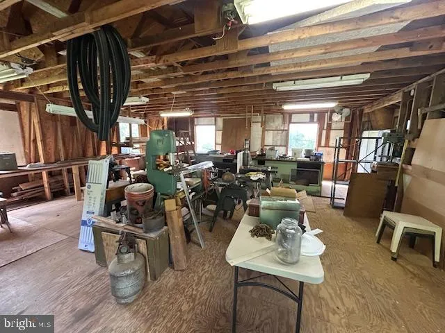 a view of a room with lots of furniture and a chandelier