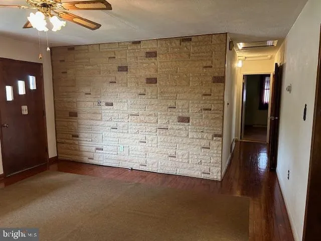 a room with a window and a ceiling fan