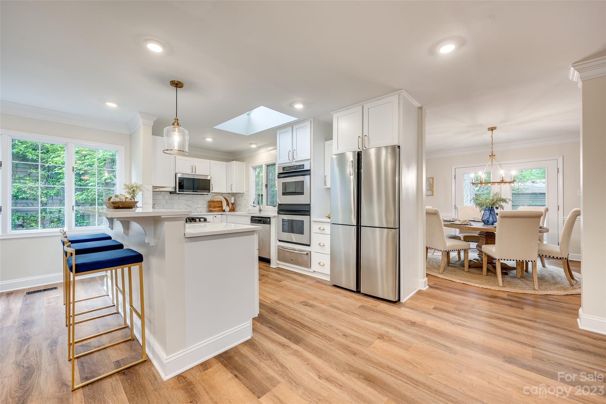 6 Sandy Cove Road Lake Wylie, SC 29710 - Photo 13 of 33 a kitchen with stainless steel appliances a refrigerator a stove a sink dishwasher with a dining table and chairs