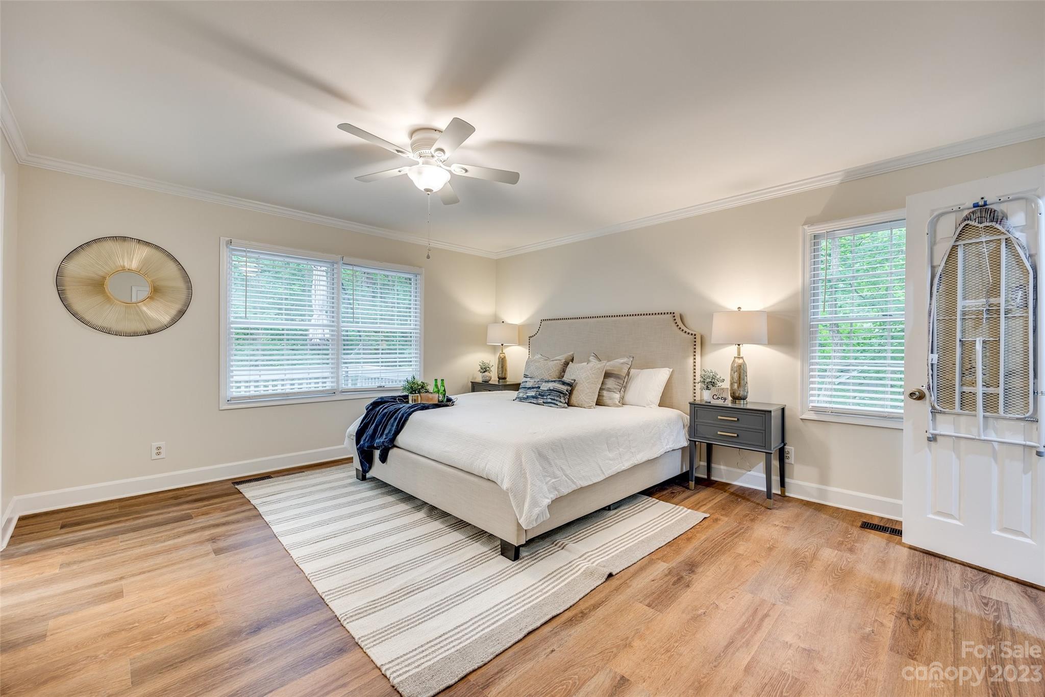 6 Sandy Cove Road Lake Wylie, SC 29710 - Photo 20 of 33 a bedroom with a large bed and a chandelier
