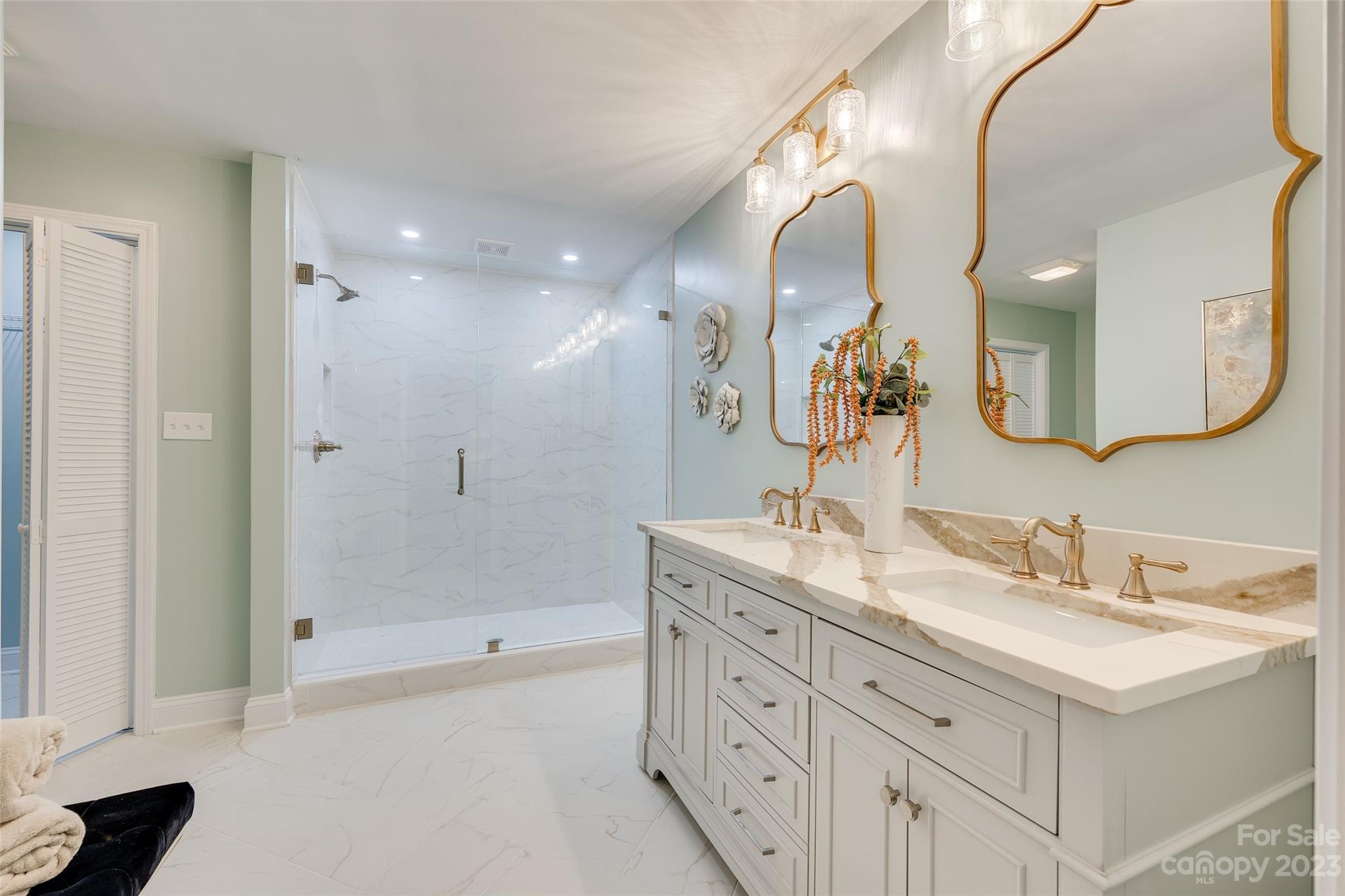 6 Sandy Cove Road Lake Wylie, SC 29710 - Photo 22 of 33 a bathroom with a double vanity sink mirror and shower