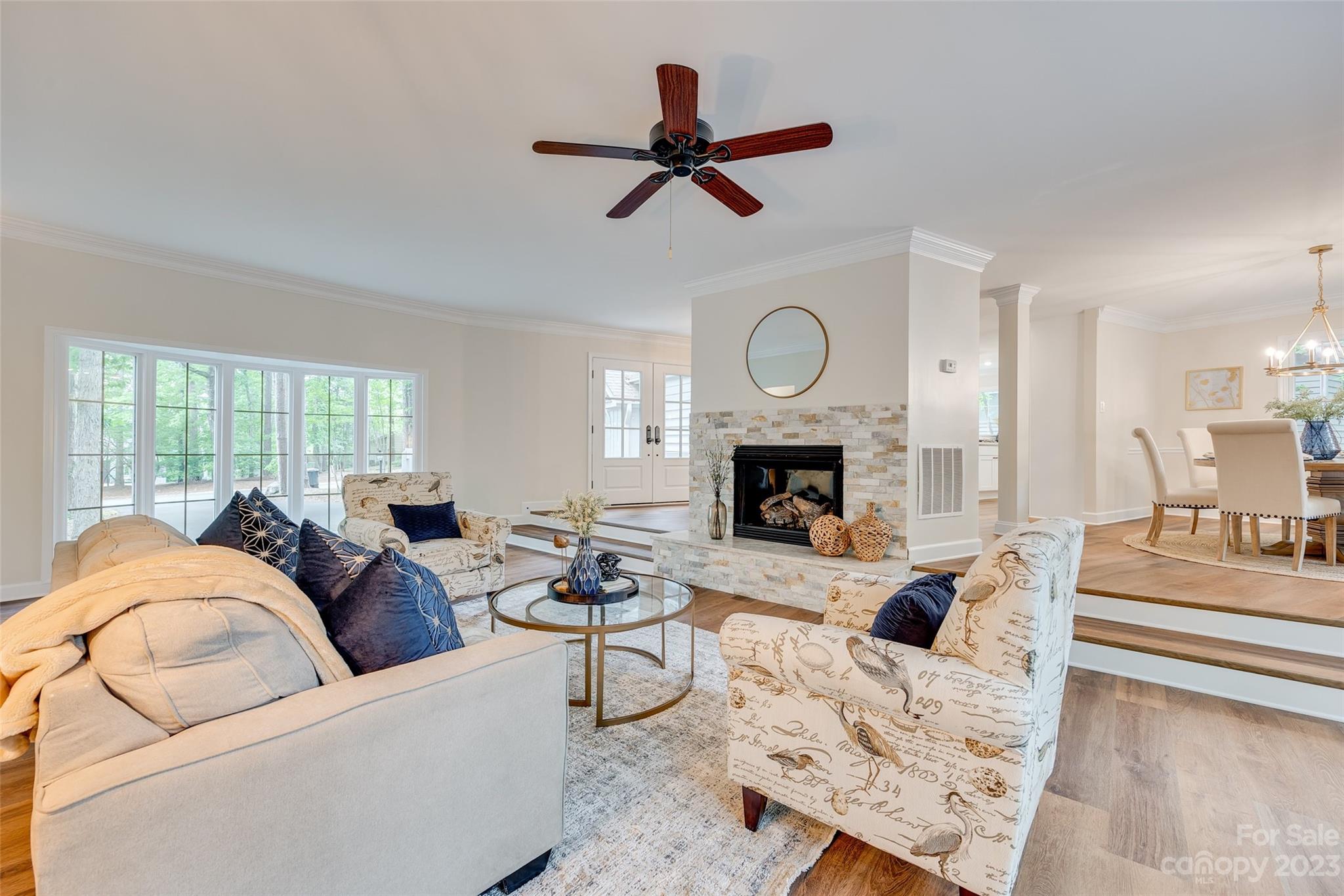 6 Sandy Cove Road Lake Wylie, SC 29710 - Photo 6 of 33 a living room with furniture a fireplace a clock and a large window