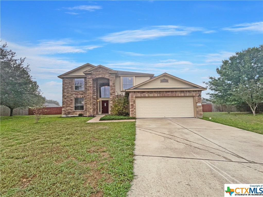 a view of a large house with a big yard and large trees