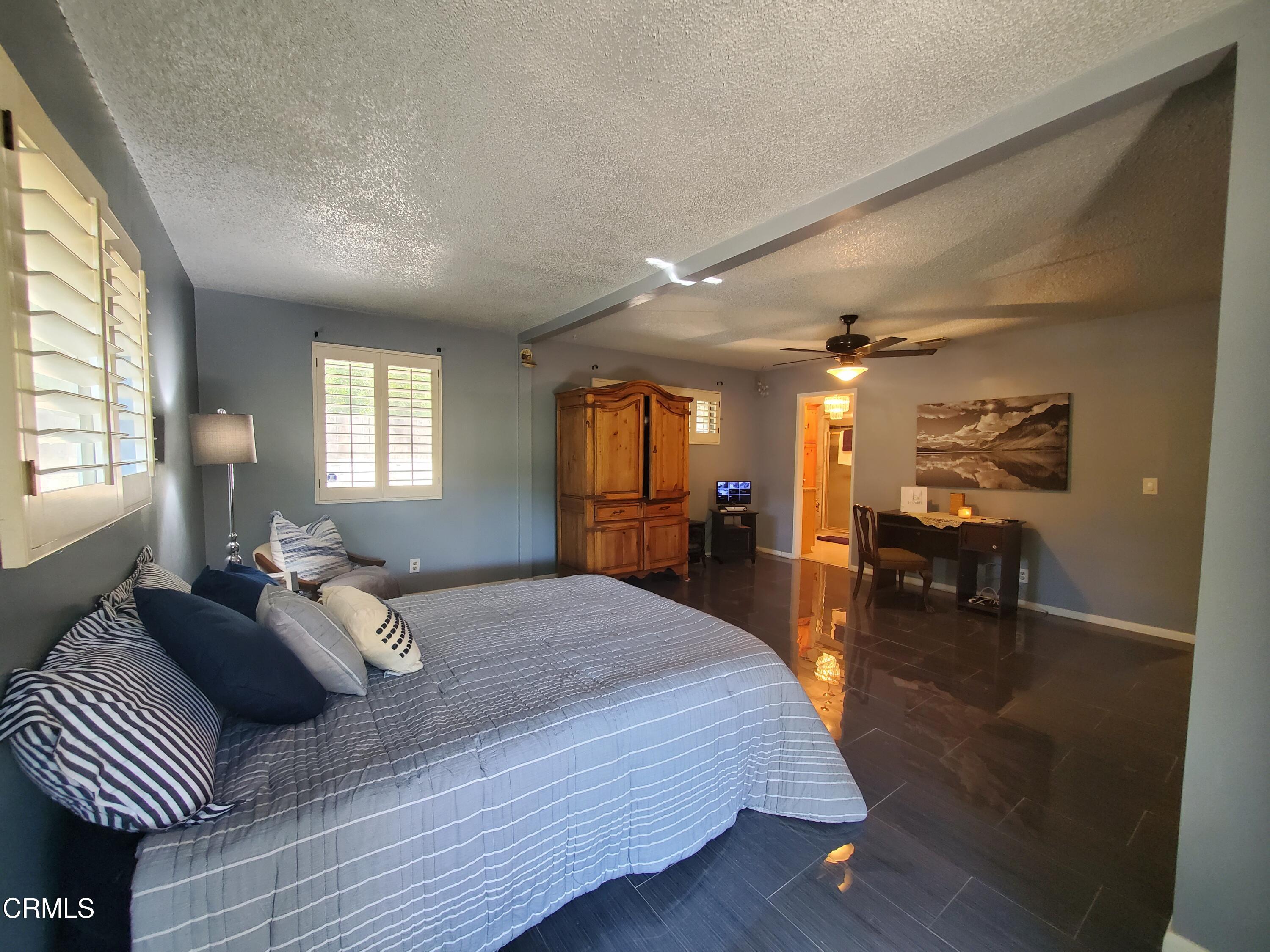 905 Chapman Avenue Pasadena, CA 91103 - Photo 18 of 20 a bedroom with a bed and a chandelier