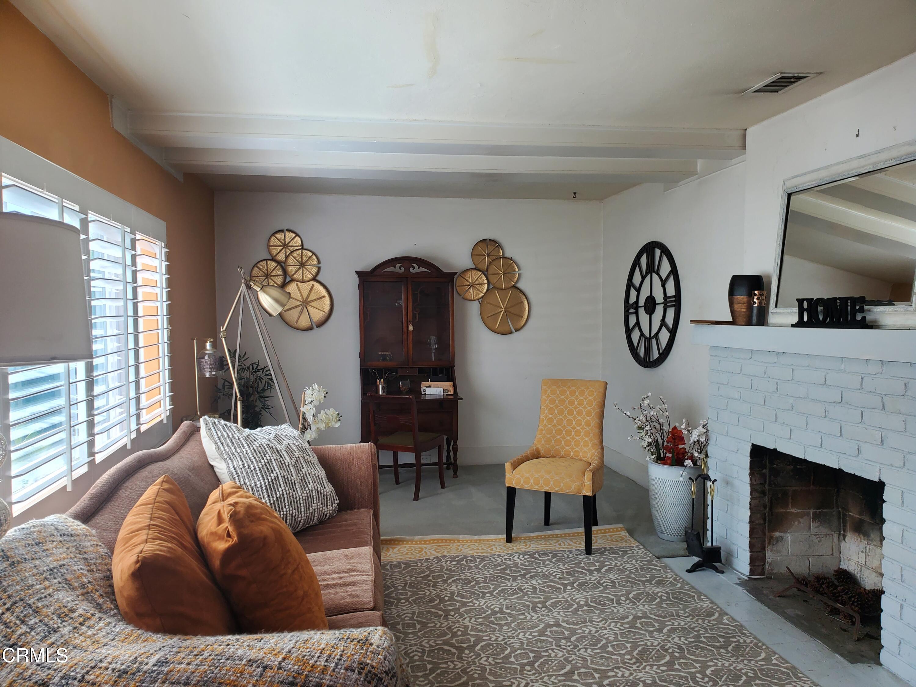 905 Chapman Avenue Pasadena, CA 91103 - Photo 3 of 20 a living room with furniture and a fireplace