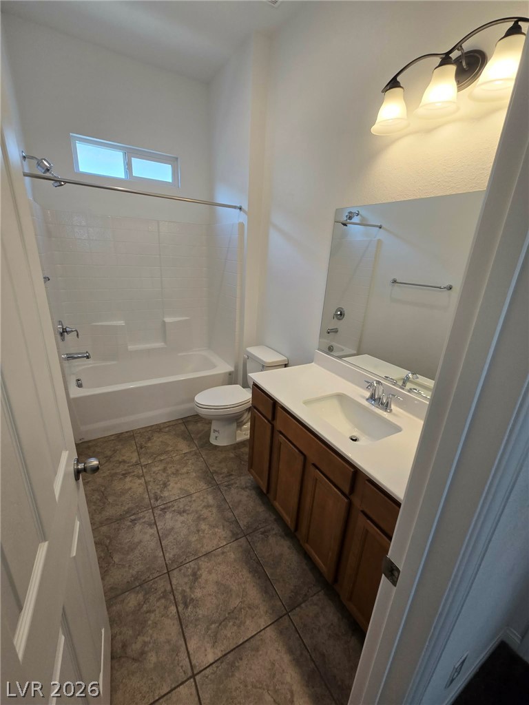 4748 Ritual Street North Las Vegas, NV 89031 - Photo 19 of 31 A well-appointed bathroom offers practical vanity storage and a clean bath-shower combination.