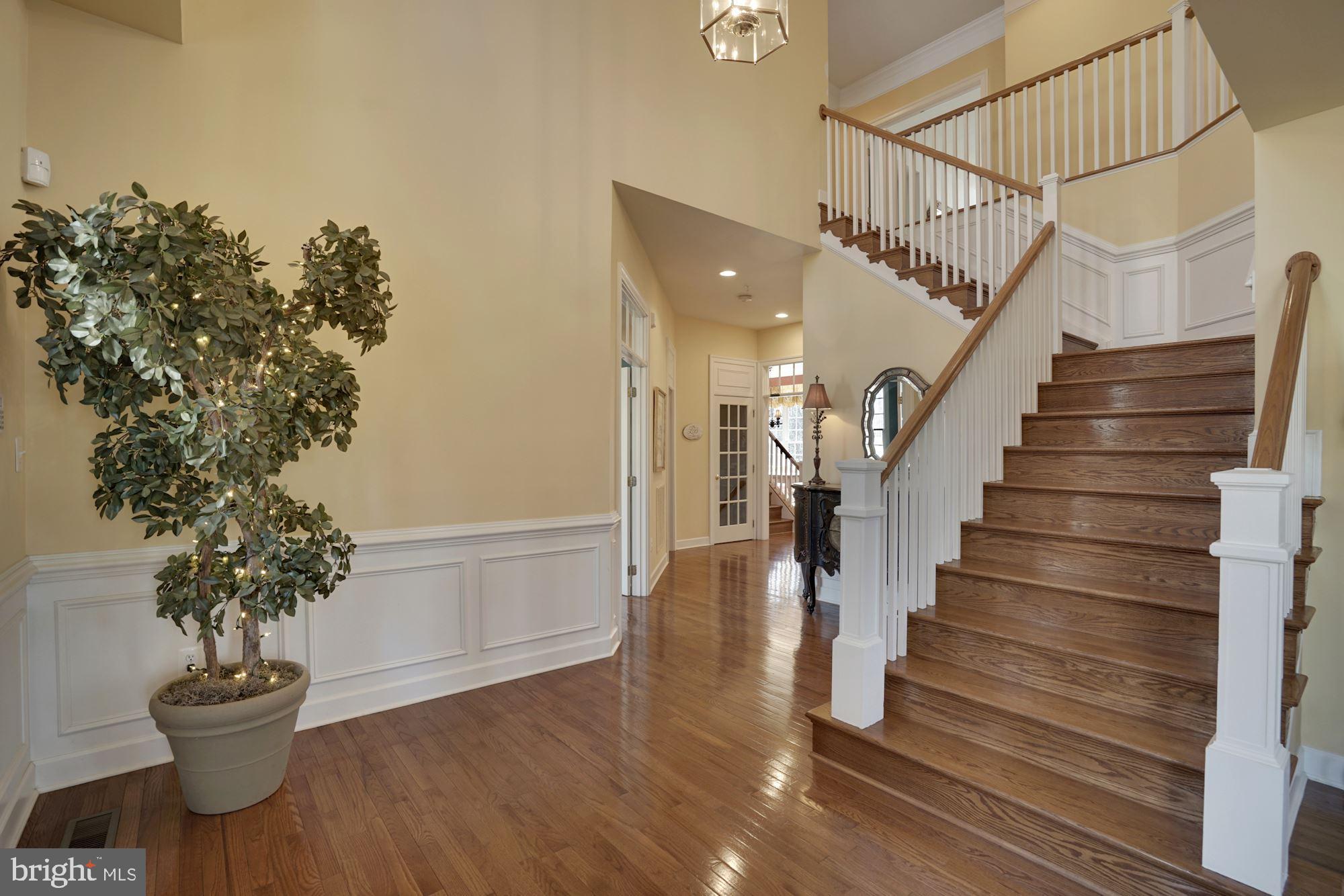 17501 Nesbitt Farm Lane Sandy Spring, MD 20860 - Photo 8 of 61 foyer with grand staircase and welcoming hardwood