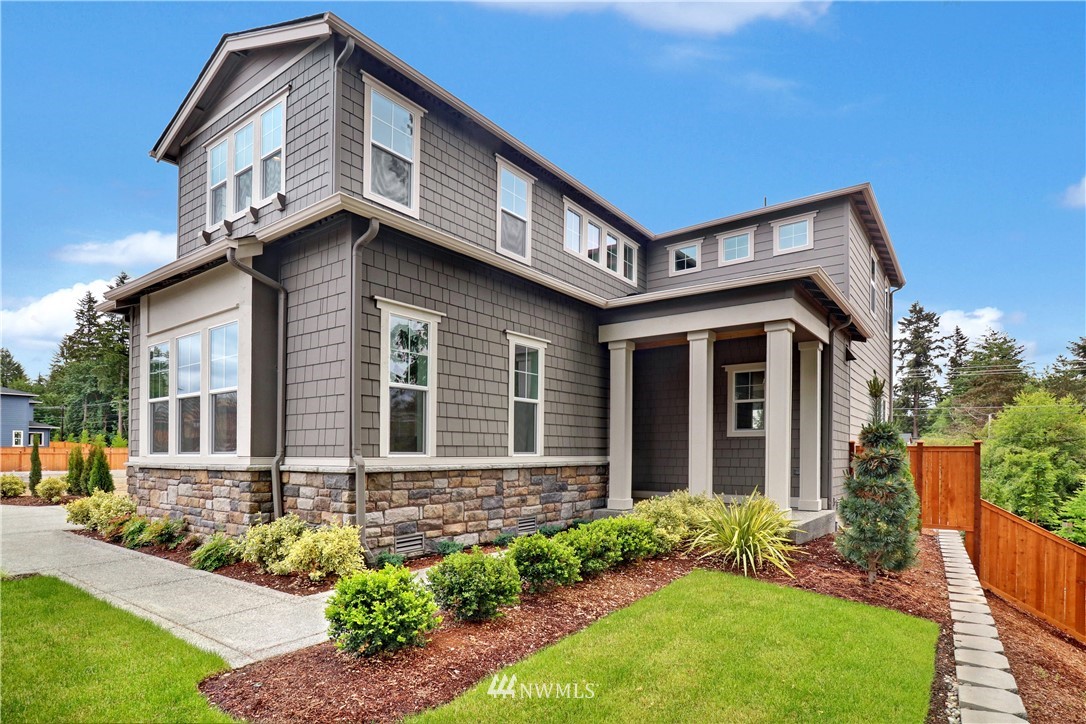 3304 219th Place Southeast, Unit 7 Bothell, WA 98021 - Photo 1 of 25 a front view of a house with garden