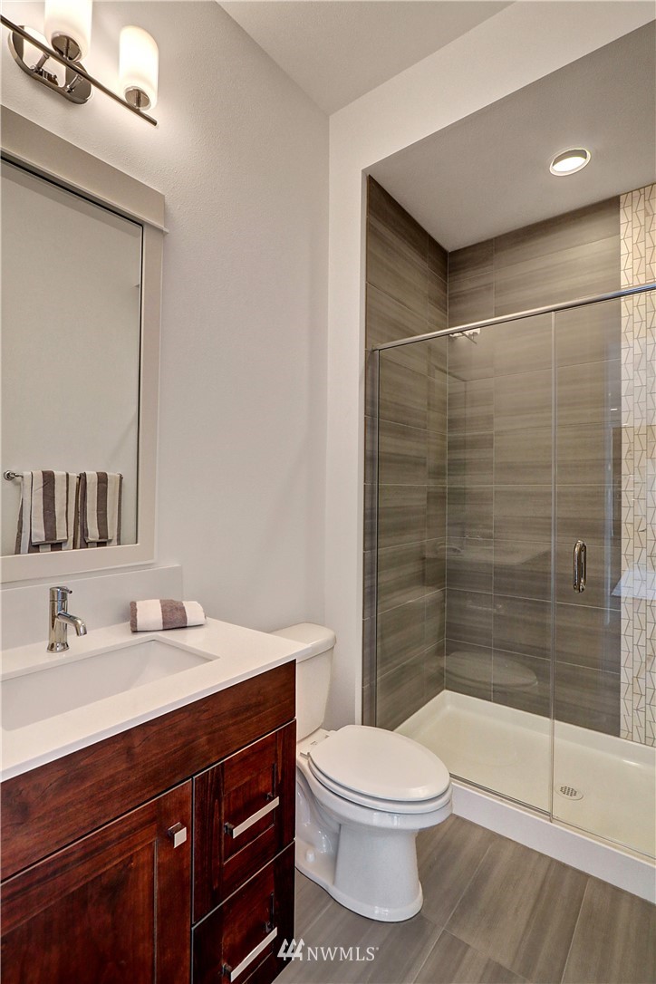 3304 219th Place Southeast, Unit 7 Bothell, WA 98021 - Photo 11 of 25 a bathroom with a sink a toilet and shower