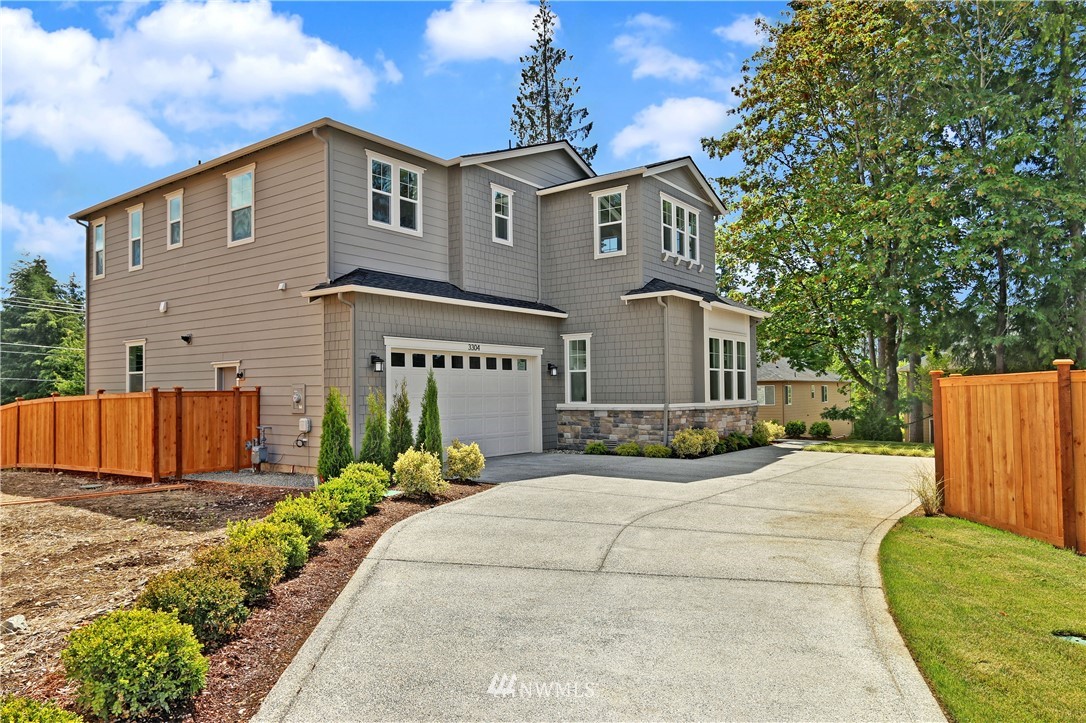 3304 219th Place Southeast, Unit 7 Bothell, WA 98021 - Photo 23 of 25 a front view of a house with a yard outdoor seating and garage