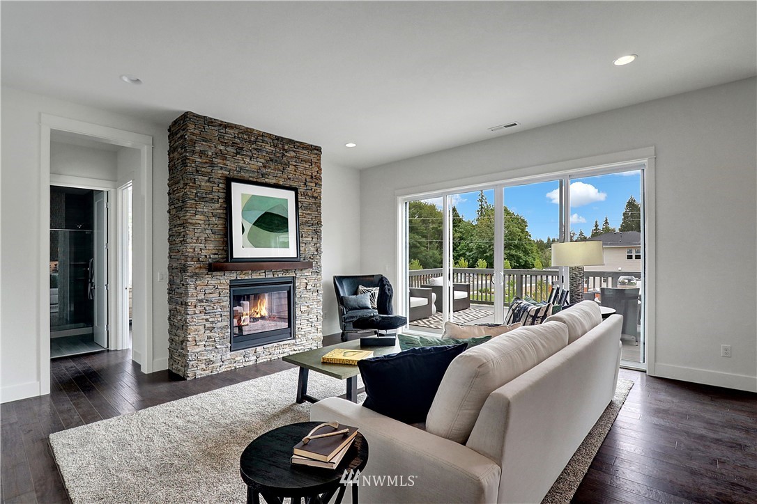 3304 219th Place Southeast, Unit 7 Bothell, WA 98021 - Photo 4 of 25 a living room with furniture and a fireplace