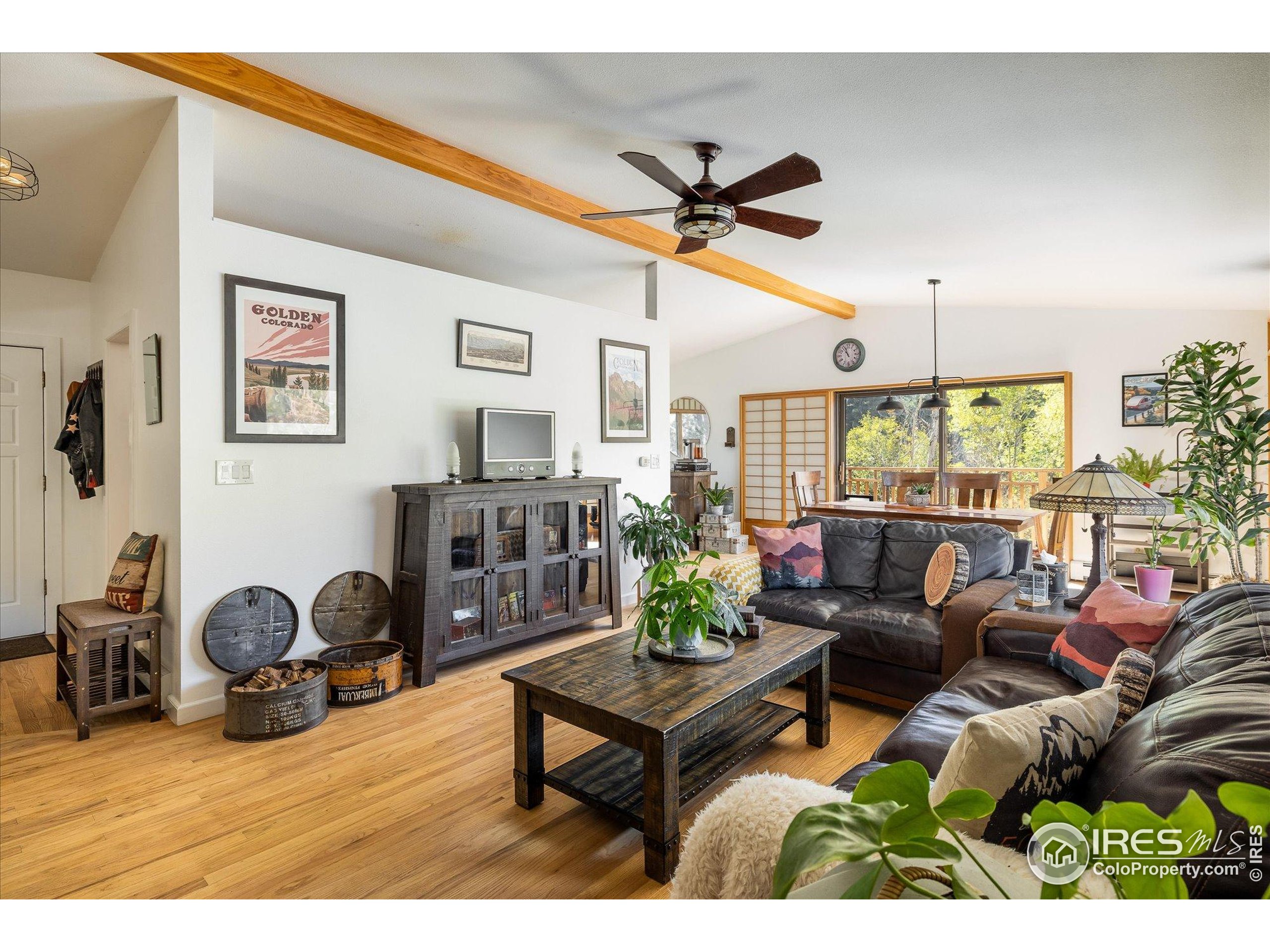 11935 Vonnie Claire Road Golden, CO 80403 - Photo 12 of 42 a living room with furniture a window and a flat screen tv